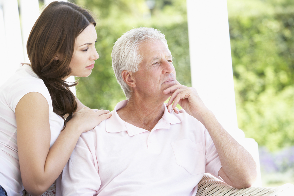 Adult Daughter Comforting Worried Father with Memory Issues